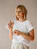 Girl drinking from Metallic rose gold glass water bottle