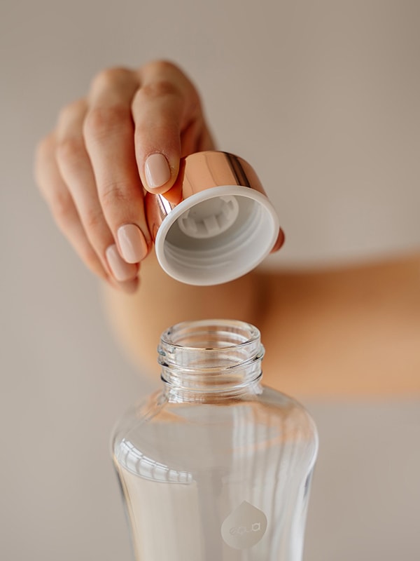 Metallic rose gold glass water bottle with rose gold lid