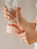 Metallic rose gold glass water bottle with bottom silicon protection