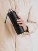 Puffy Black Glass Bottle in hands