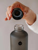 EQUA glass water bottle Ash and the mouth of the bottle with the lid cover.