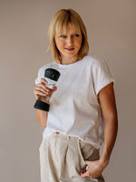 Girl holding Active Black glass bottle