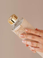 EQUA glass water bottle in beige colour.