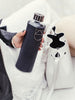 EQUA glass water bottle Graphite holding in hand.
