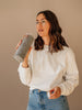 Girl drinking from EQUA glass water bottle Rose Gold.