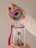 EQUA Bottiglia d'acqua BPA FREE, Dandelion, primo piano del coperchio, colore rosa e grigio