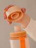 EQUA BPA FREE water bottle, Sunrise, close up of the lid and mouthpiece, peach color