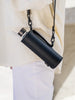 EQUA glass bottle in black faux leather bag with a long black strap. 