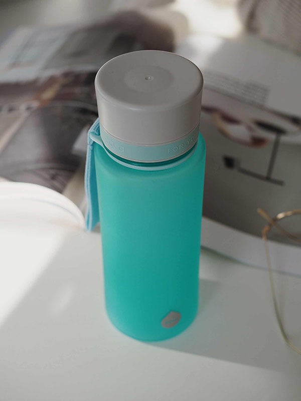 EQUA Bouteille d'eau SANS BPA, Océan, gros plan de la bouteille d'eau sur la table du bureau, design minimaliste, sans motif, couleur bleue
