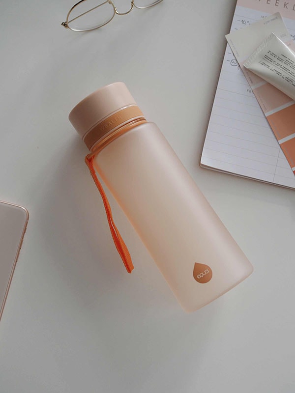 EQUA BPA FREE water bottle, Sunrise, water bottle on the office table, minimalistic design, no motif, peach color
