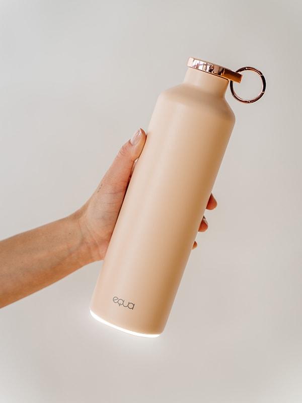 EQUA Smart Water Bottle in Pink Blush Colour and rose gold lid and holder ring details in the center of the image.