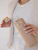 Gold lid and details of glass water bottle with beige colour cover - Sienna by EQUA