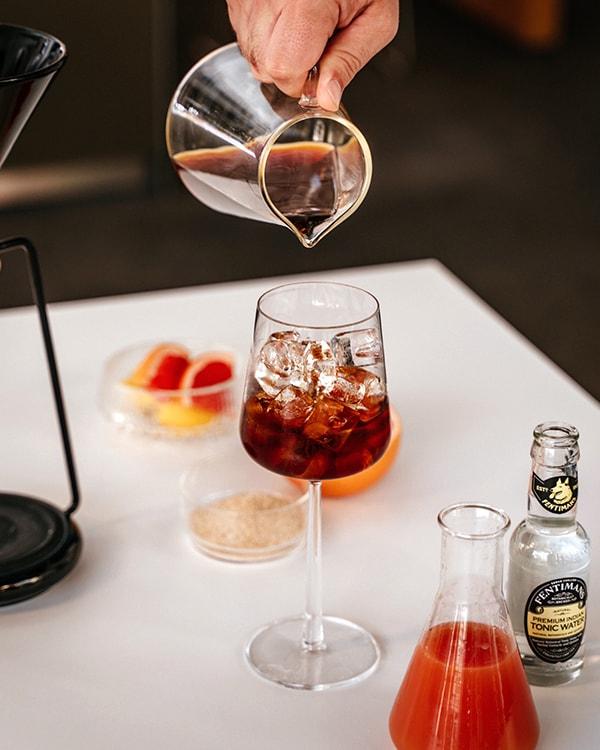 GINA Black with pitcher pouring specialty coffee